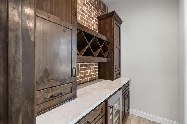 a view of open kitchen with stainless steel appliances kitchen island a large counter space and wooden floor