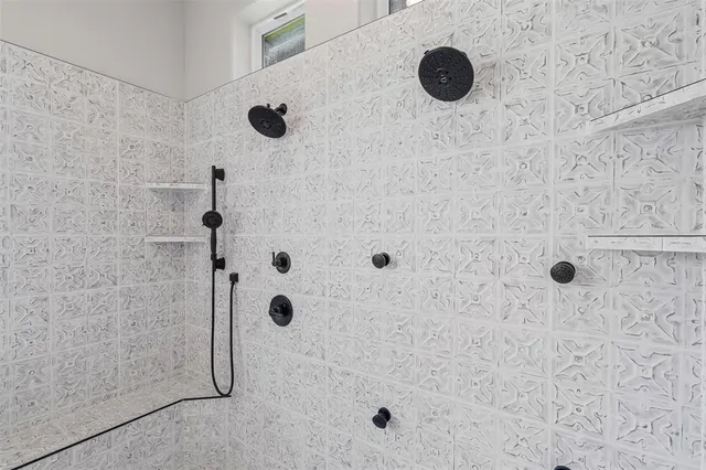 a bathroom with a granite countertop sink mirror and shower