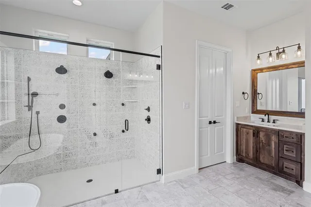 a spacious bathroom with a granite countertop sink and a mirror