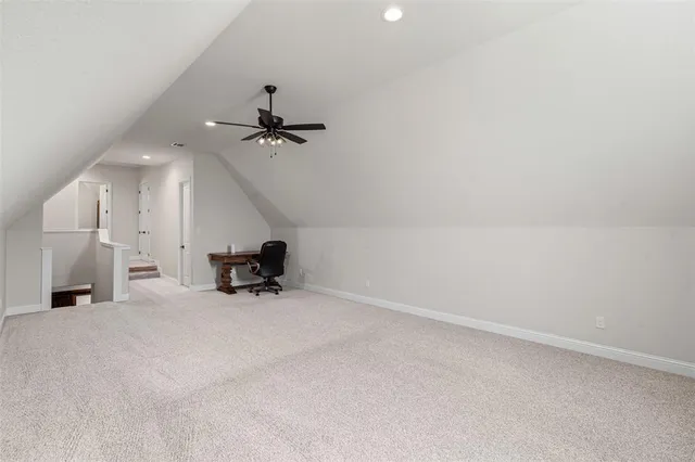 a bathroom with a granite countertop toilet sink and mirror