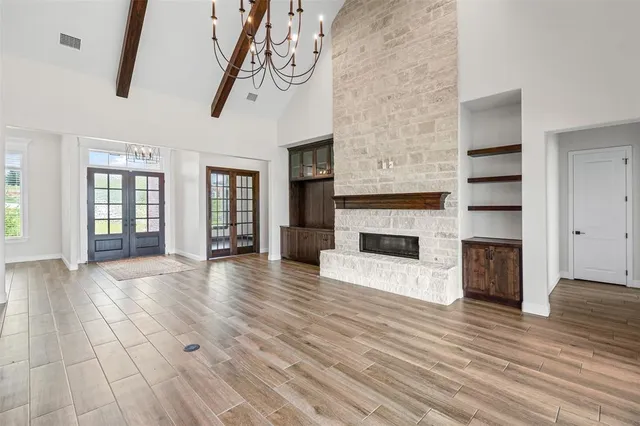 a view of a livingroom with wooden floor and a fireplace