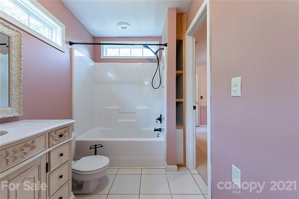 943 Knightsbridge Road Fort Mill, SC 29708 - Photo 14 of 21 a bathroom with a granite countertop toilet a sink and a mirror
