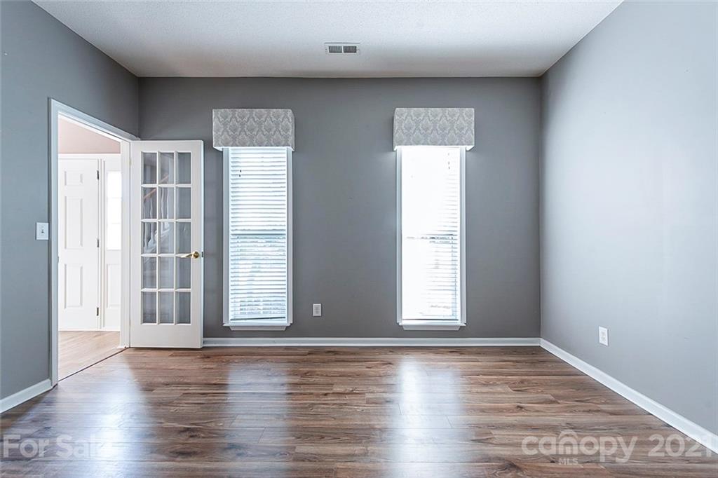 943 Knightsbridge Road Fort Mill, SC 29708 - Photo 5 of 21 an empty room with wooden floor and windows