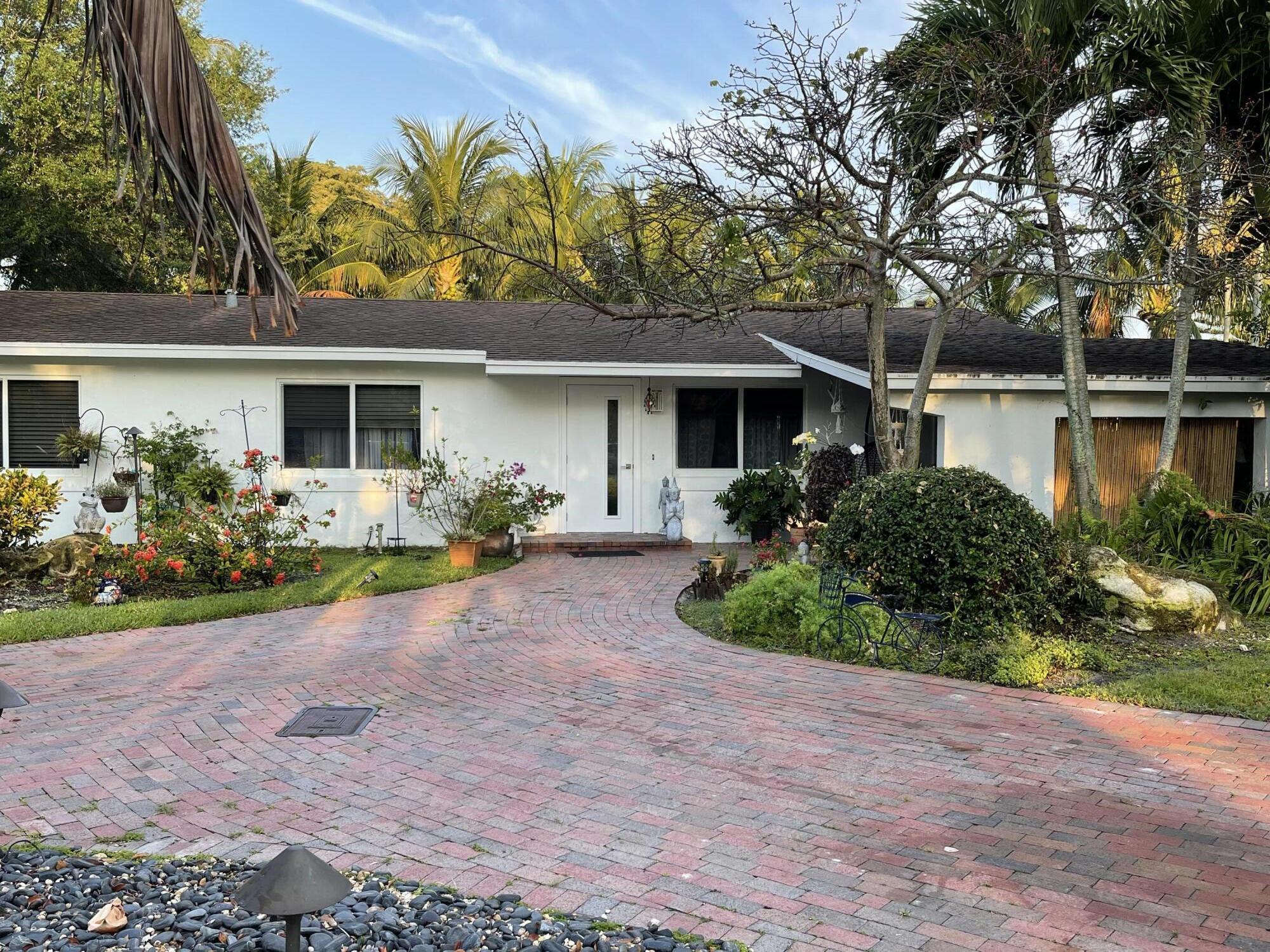 7 Polo Circle Boca Raton, FL 33431 - Photo 3 of 4 a front view of a house with garden