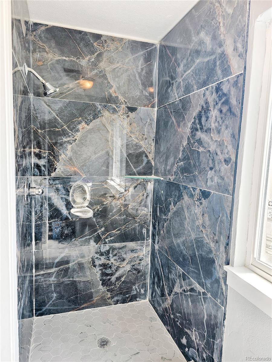 4716 Freeport Way Denver, CO 80239 - Photo 14 of 29 a bathroom with a shower