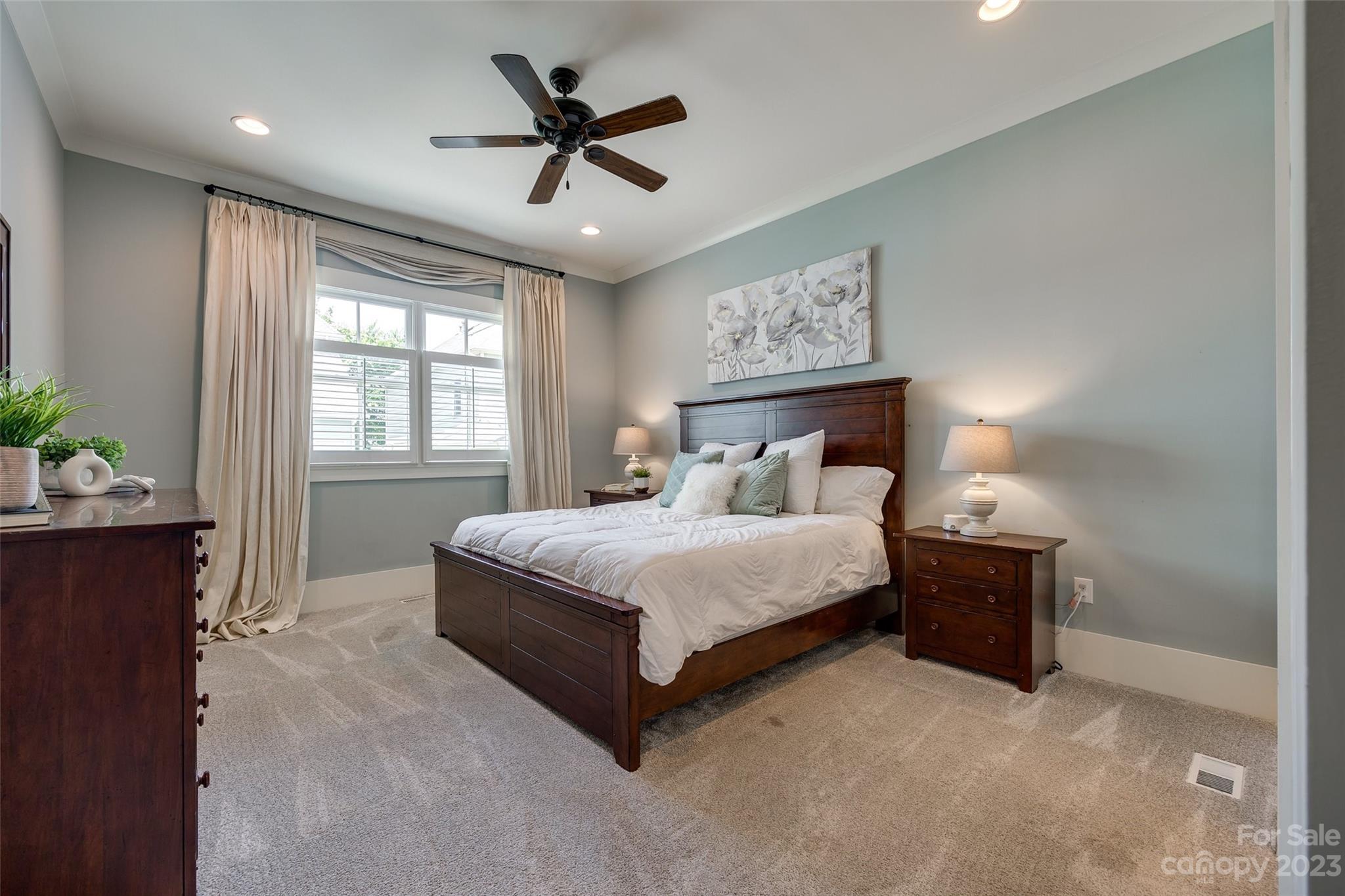 3213 Fifth Baxter Crossing Fort Mill, SC 29708 - Photo 14 of 30 a bedroom with a bed and a chandelier