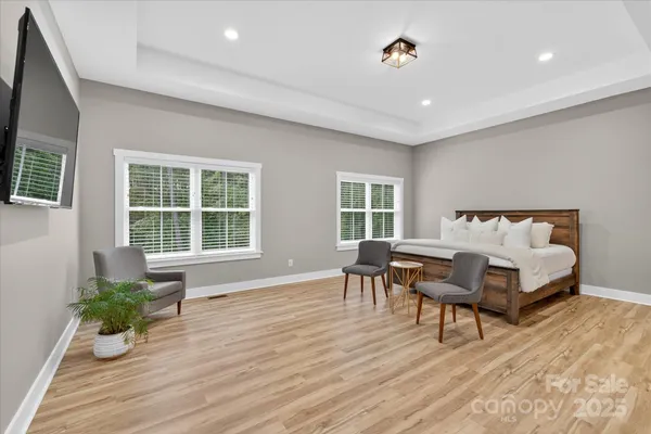 a spacious bedroom with a bed and a table in it