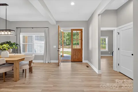 a view of a livingroom with furniture window and wooden floor