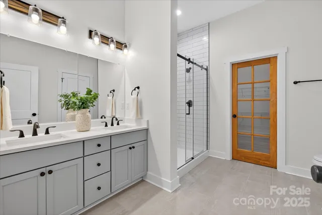 a bathroom with a double vanity sink mirror and double