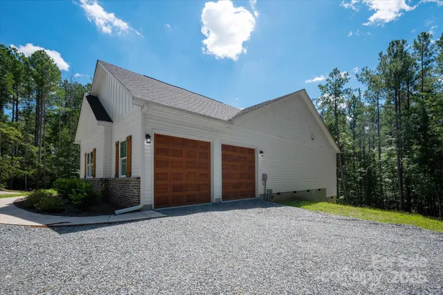 a view of a house with a yard and garage