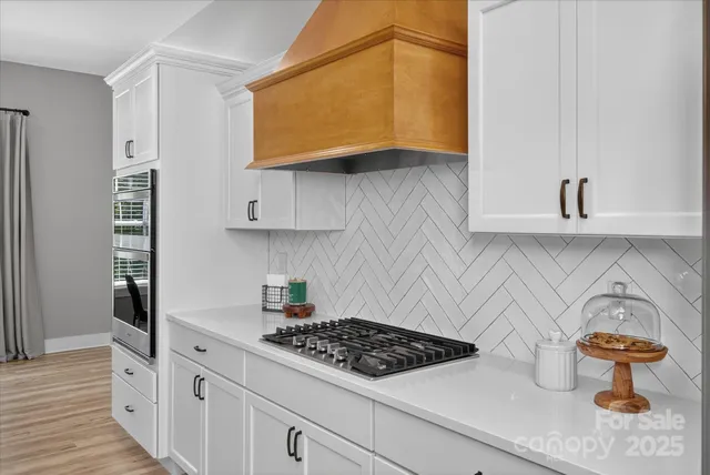 a kitchen with stainless steel appliances granite countertop a lot of cabinets a stove and dishwasher