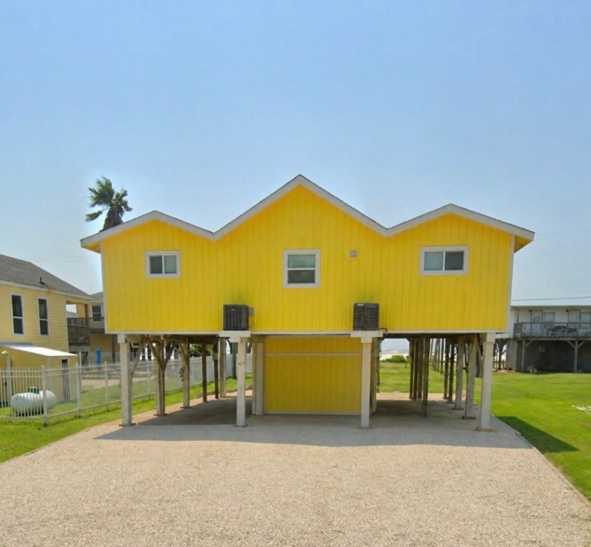 407 Seashell Drive Surfside Beach, TX 77541 - Photo 2 of 18 a view of a house with a swimming pool and a yard