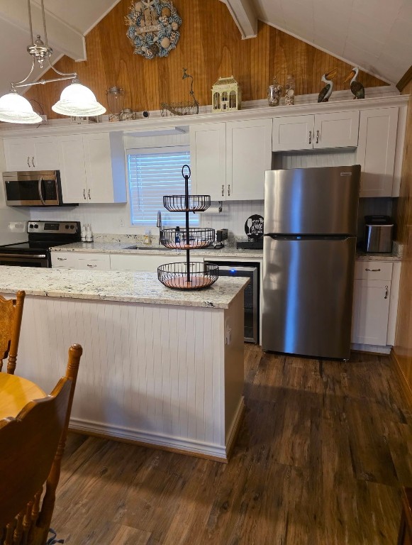 407 Seashell Drive Surfside Beach, TX 77541 - Photo 5 of 18 a kitchen with kitchen island a sink appliances and cabinets