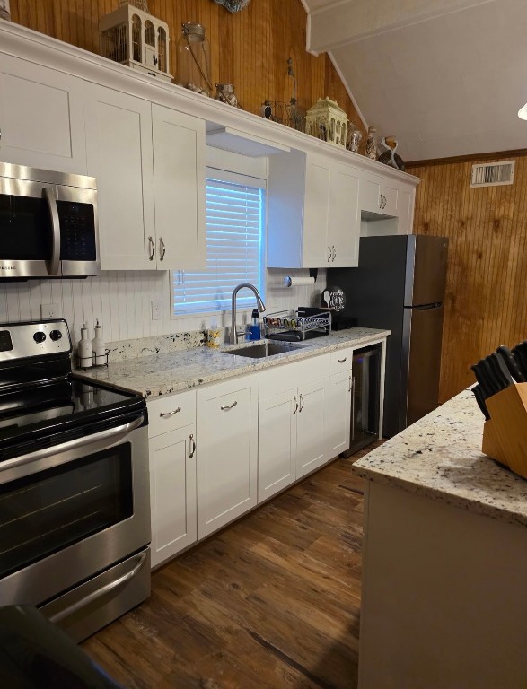 407 Seashell Drive Surfside Beach, TX 77541 - Photo 6 of 18 a kitchen with stainless steel appliances kitchen island granite countertop a sink stove and refrigerator