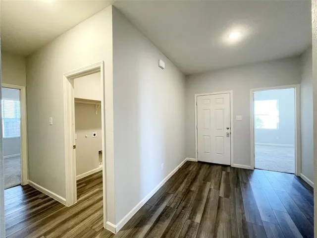 a view of a hallway with wooden floor