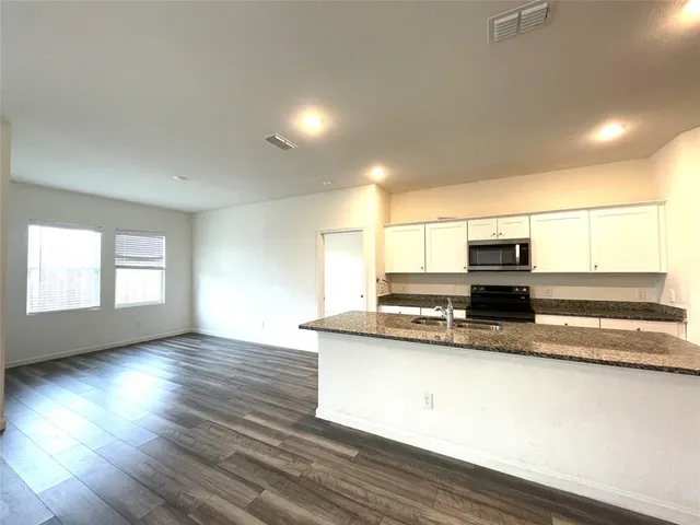 a bathroom with a granite countertop toilet and a shower