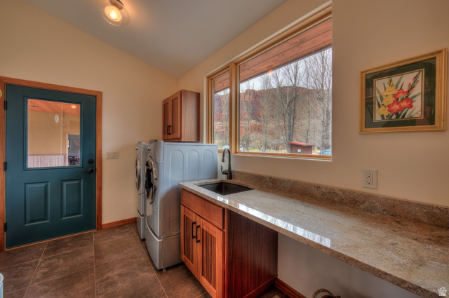 425 Amber Lane Moab, UT 84532 - Photo 21 of 27 Laundry area with vaulted ceiling, washer and dryer, and cabinet space
