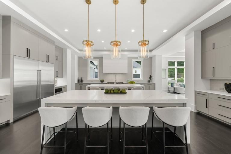5211 Powers Ferry Road Northwest Sandy Springs, GA 30327 - Photo 19 of 106 a kitchen with stainless steel appliances kitchen island granite countertop a dining table chairs and white cabinets