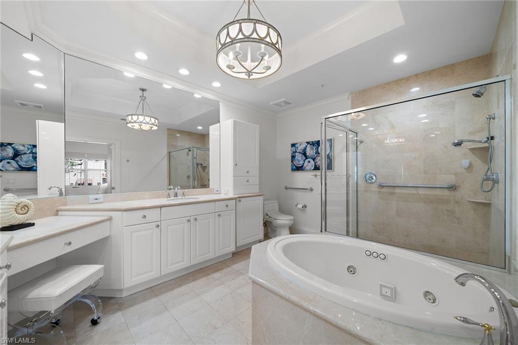 411 6th Street South, Unit 202 Naples, FL 34102 - Photo 15 of 35 a bathroom with a tub a sink and a large mirror