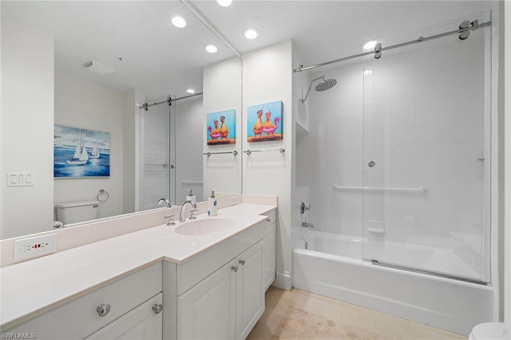 411 6th Street South, Unit 202 Naples, FL 34102 - Photo 18 of 35 a bathroom with a double vanity sink mirror double and shower