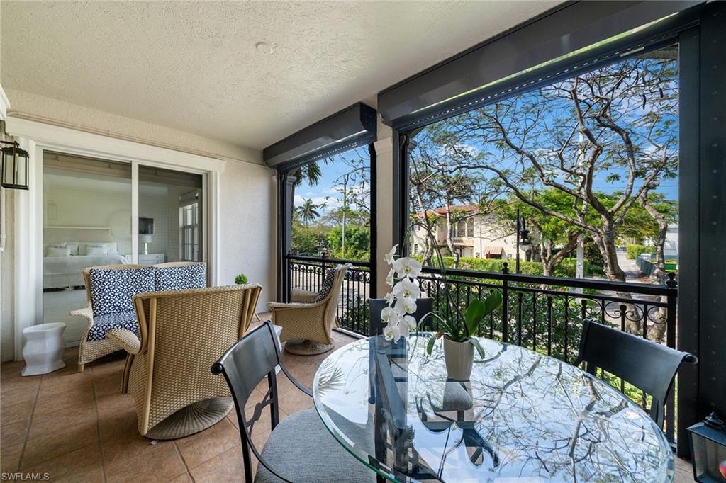 411 6th Street South, Unit 202 Naples, FL 34102 - Photo 22 of 35 a view of a dining room with furniture large windows and wooden floor