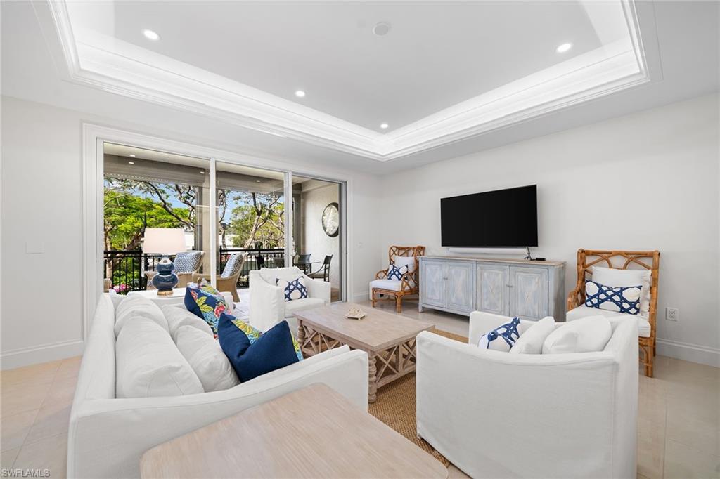 411 6th Street South, Unit 202 Naples, FL 34102 - Photo 3 of 35 a living room with furniture and a flat screen tv