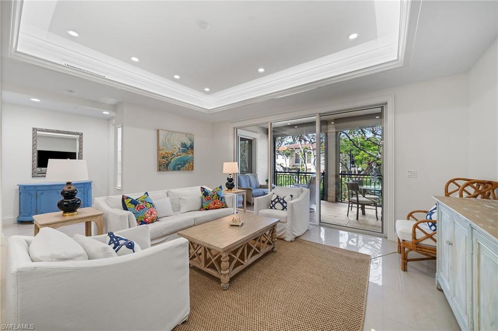 411 6th Street South, Unit 202 Naples, FL 34102 - Photo 4 of 35 a living room with furniture and a large window