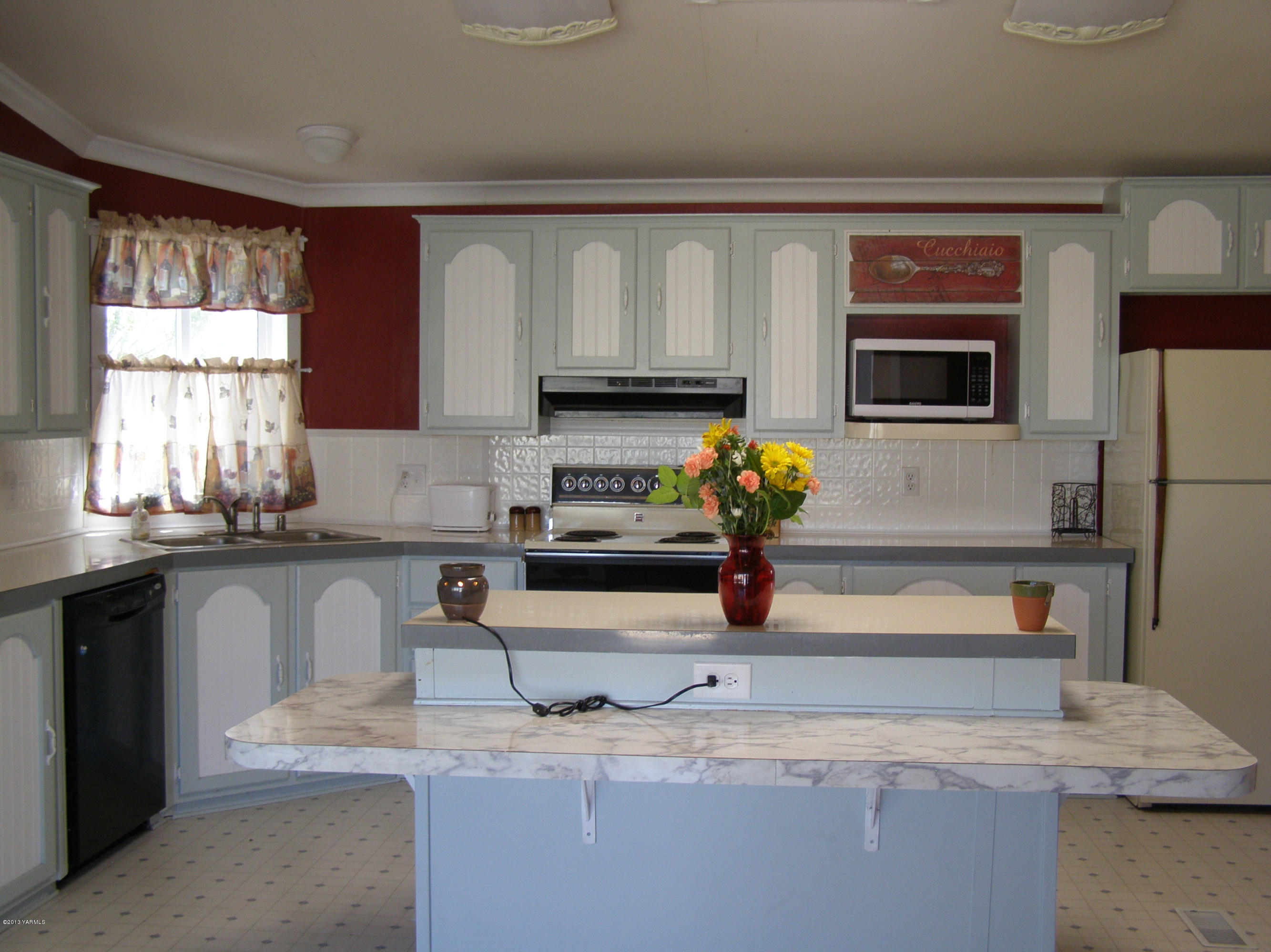2511 Cook Road Yakima, WA 98908 - Photo 11 of 27 a kitchen with a sink a stove and a window