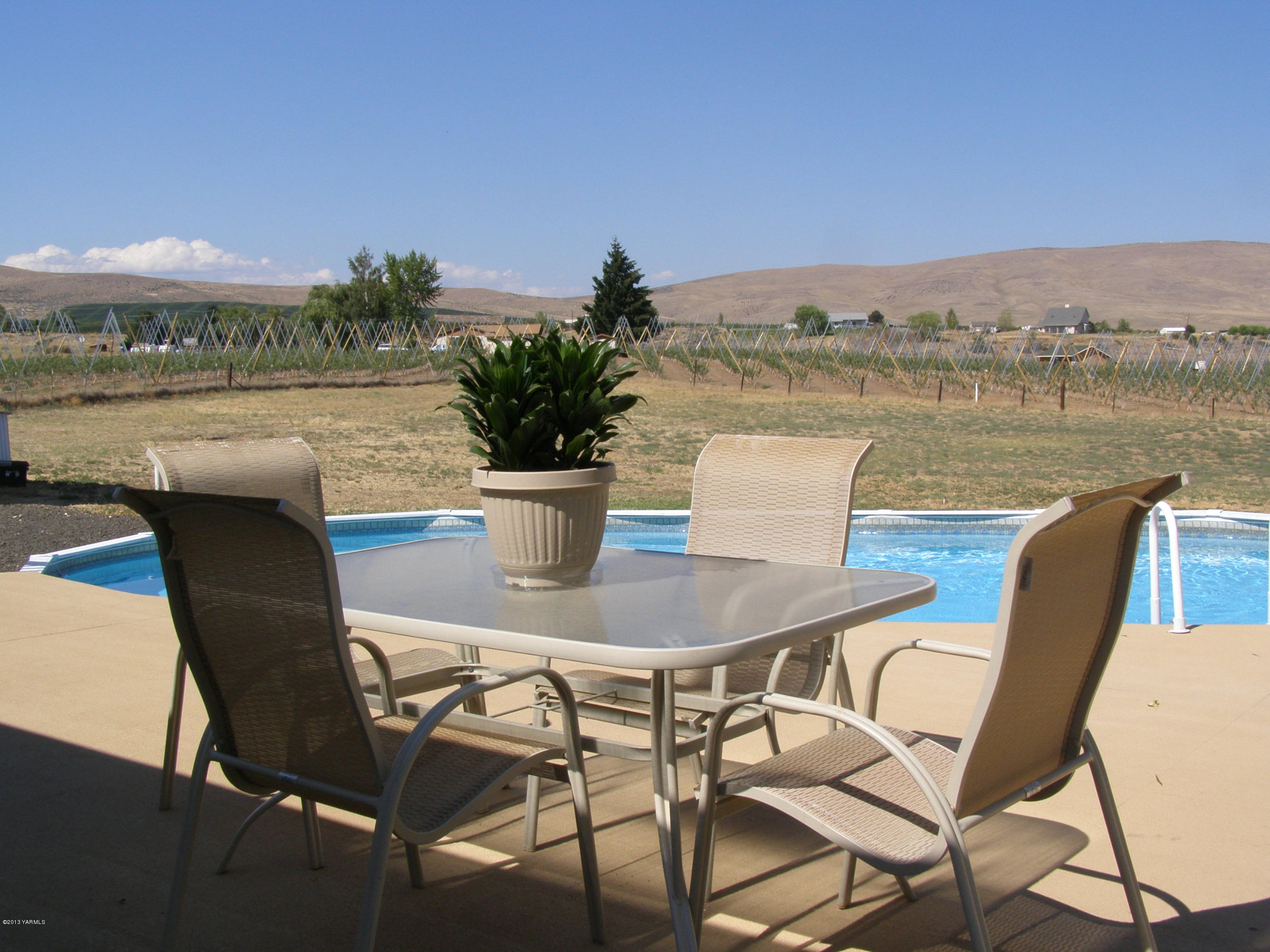 2511 Cook Road Yakima, WA 98908 - Photo 22 of 27 a view of a lake with table and chairs