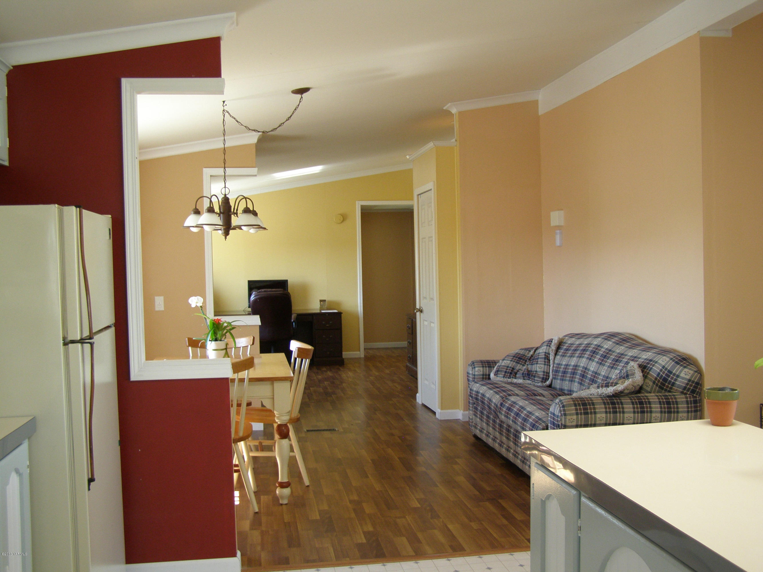 2511 Cook Road Yakima, WA 98908 - Photo 6 of 27 a living room with a table chairs and a refrigerator