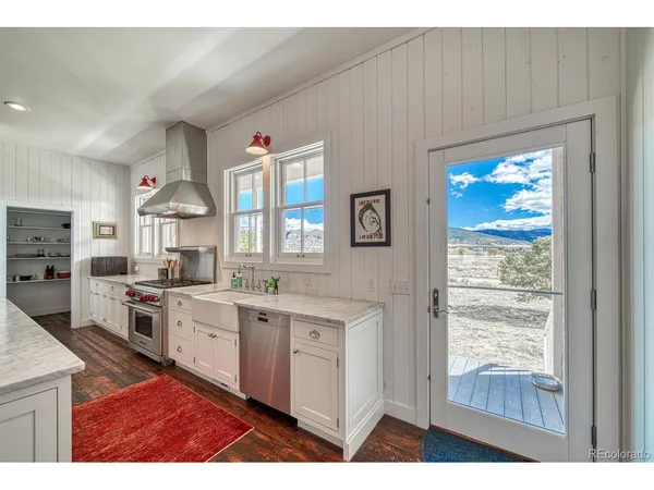 a living room with furniture and a book shelf