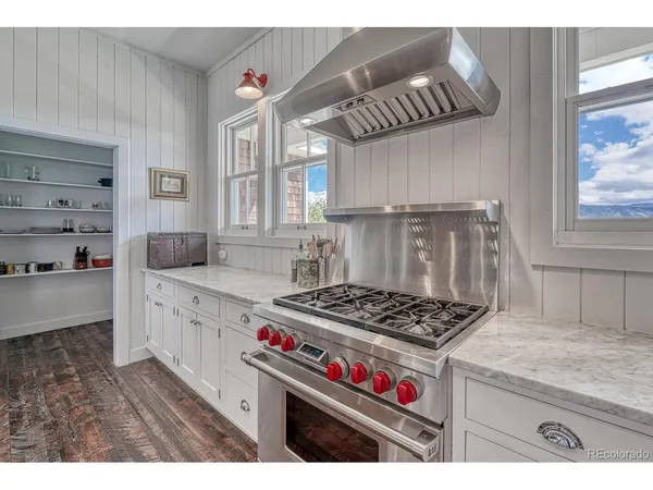 a kitchen with kitchen island a counter top space a sink and a refrigerator