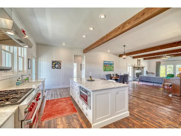 a kitchen with granite countertop a stove and a sink