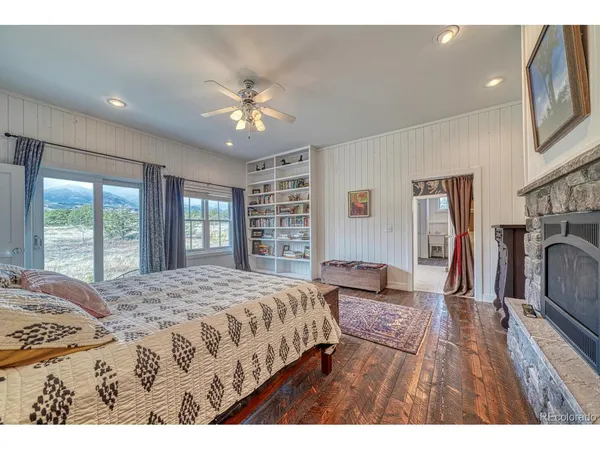 a bedroom with a large bed and a chandelier