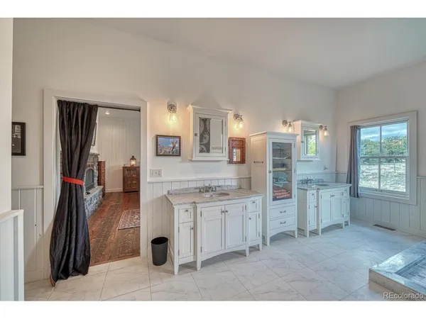 a bathroom with a granite countertop sink a mirror and a shower