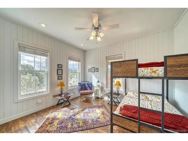 a bathroom with a granite countertop sink a toilet a mirror and bathtub