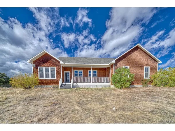 a living room with furniture a chandelier and a window