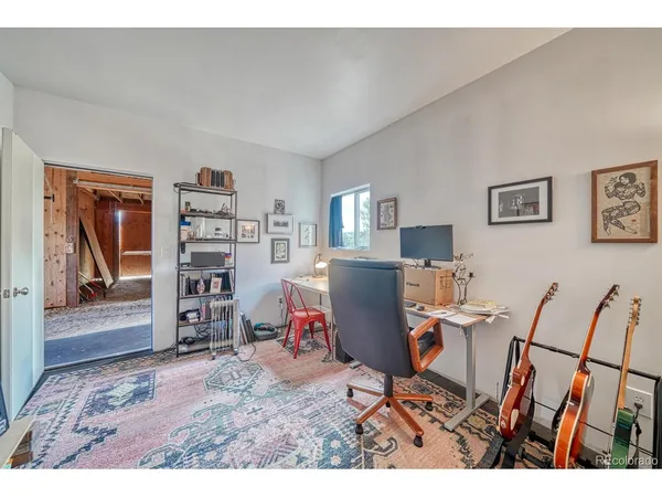a living room with furniture a piano and a fireplace