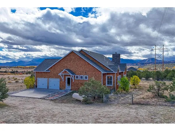 a view of a pathway with a field in the back