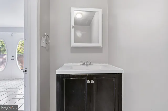 a view of an empty room with wooden floor and windows
