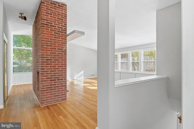 a kitchen with stainless steel appliances granite countertop a refrigerator a stove and a sink with wooden floor