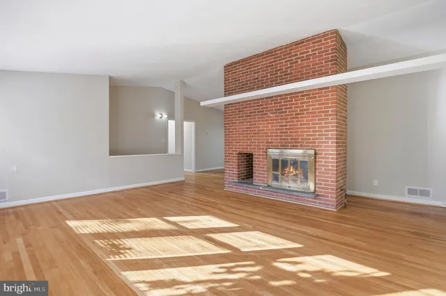 a view of a kitchen with a refrigerator cabinets and a wooden floor