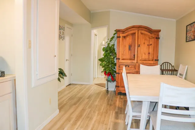 a dining room with furniture and wooden floor