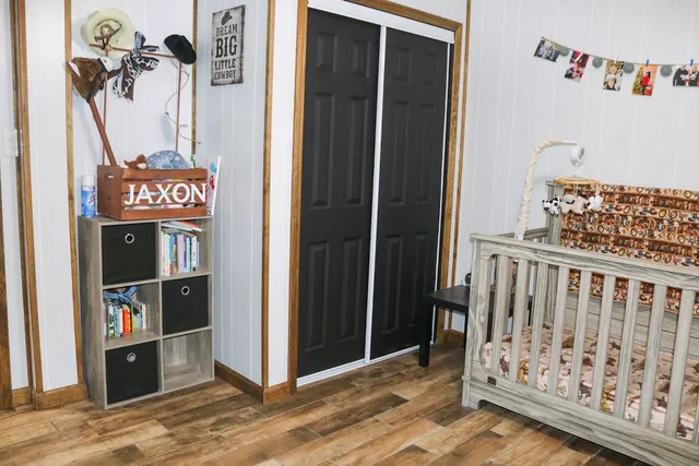 a view of a hallway with wooden floor and entryway
