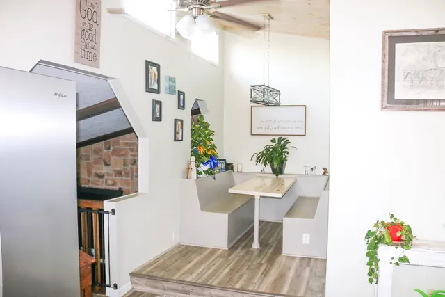 a view of a hallway with furniture and a potted plant