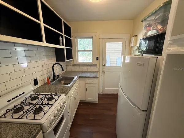 a kitchen with a stove and a refrigerator