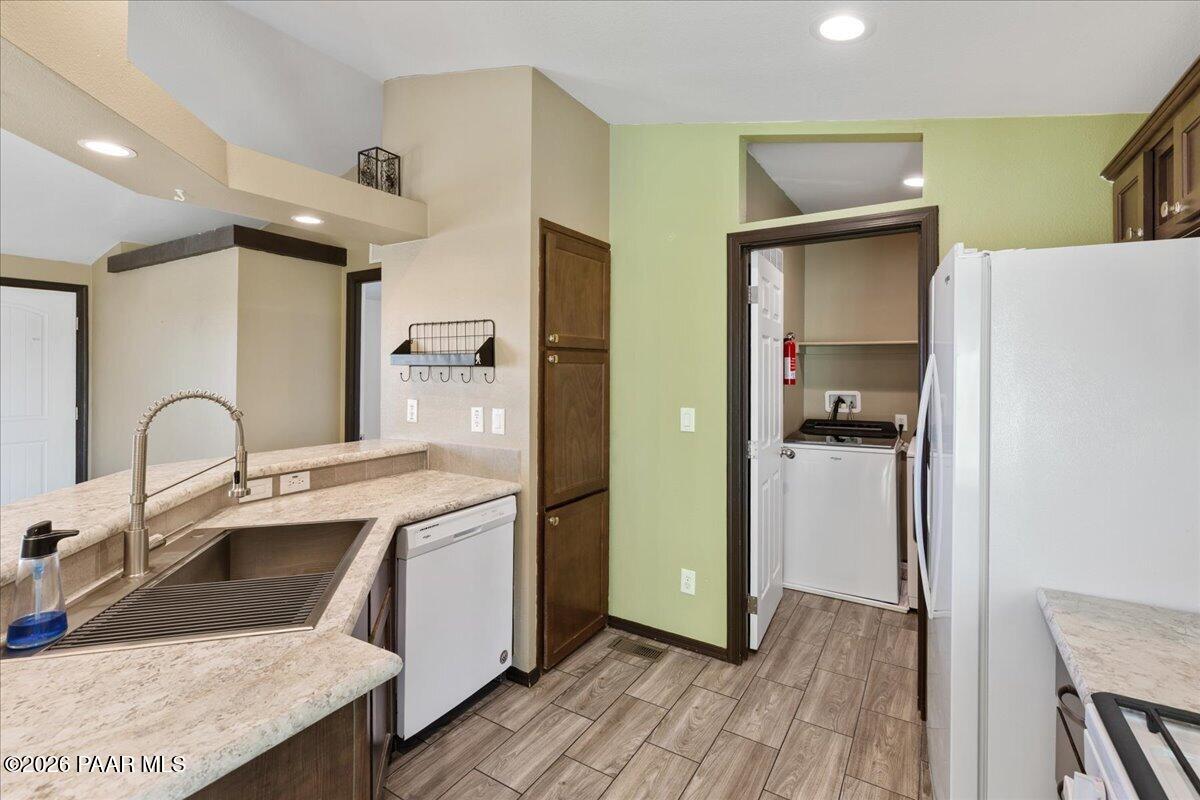 325 East Houston Road Paulden, AZ 86334 - Photo 13 of 40 a kitchen with a sink a refrigerator and cabinets