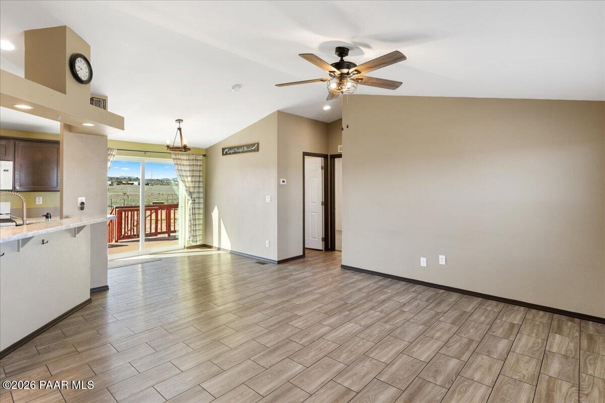 325 East Houston Road Paulden, AZ 86334 - Photo 2 of 40 a view of a kitchen with furniture and a ceiling fan