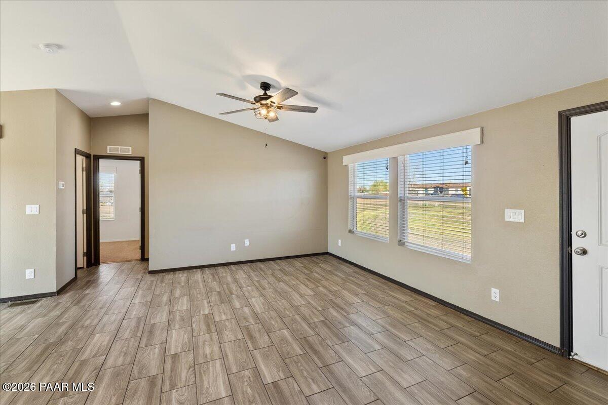 325 East Houston Road Paulden, AZ 86334 - Photo 7 of 40 a view of an empty room with a window and wooden floor