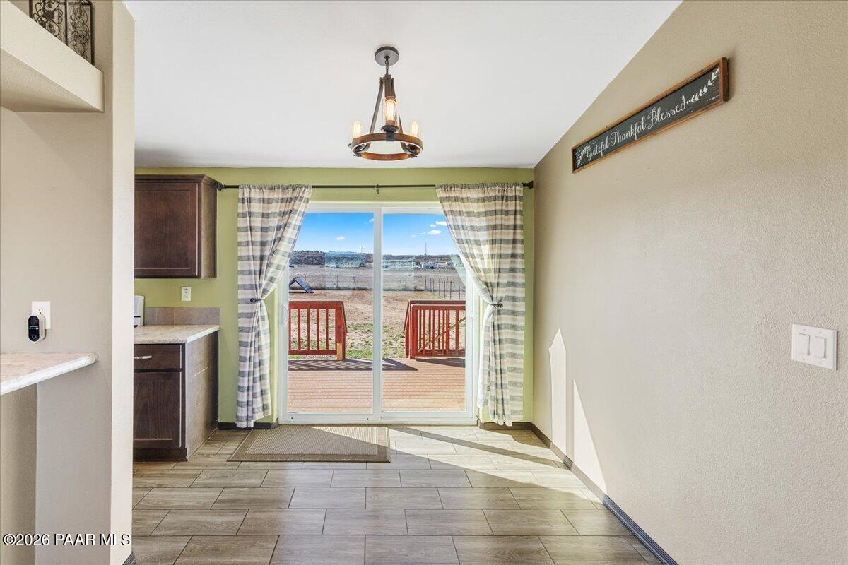325 East Houston Road Paulden, AZ 86334 - Photo 9 of 40 a view of a hallway with a fireplace and chandelier